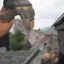 Bat removal technician safely handling a bat near a roofline in {city}, {state}